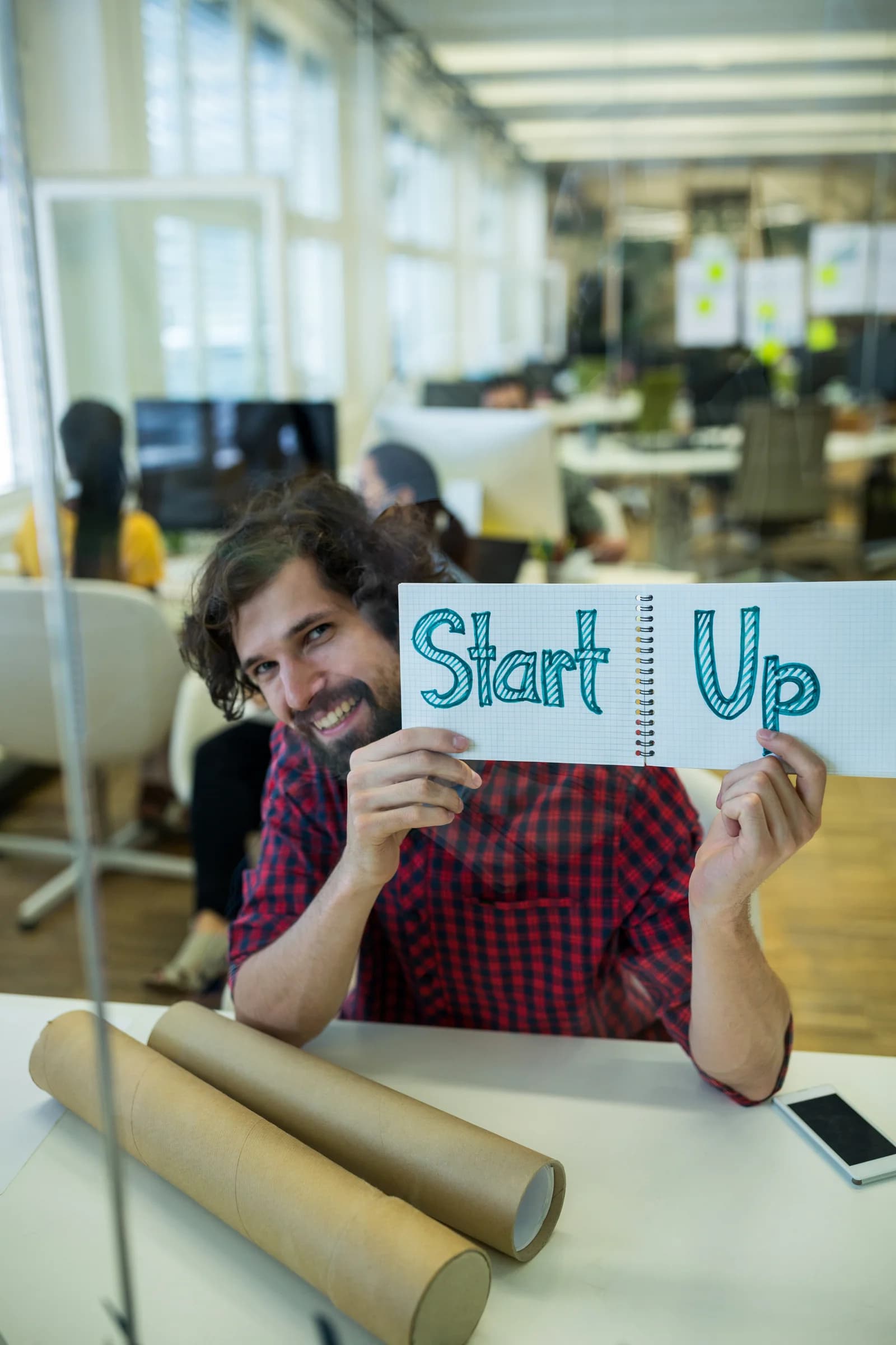 A designer sharing a startup idea on a notepad
