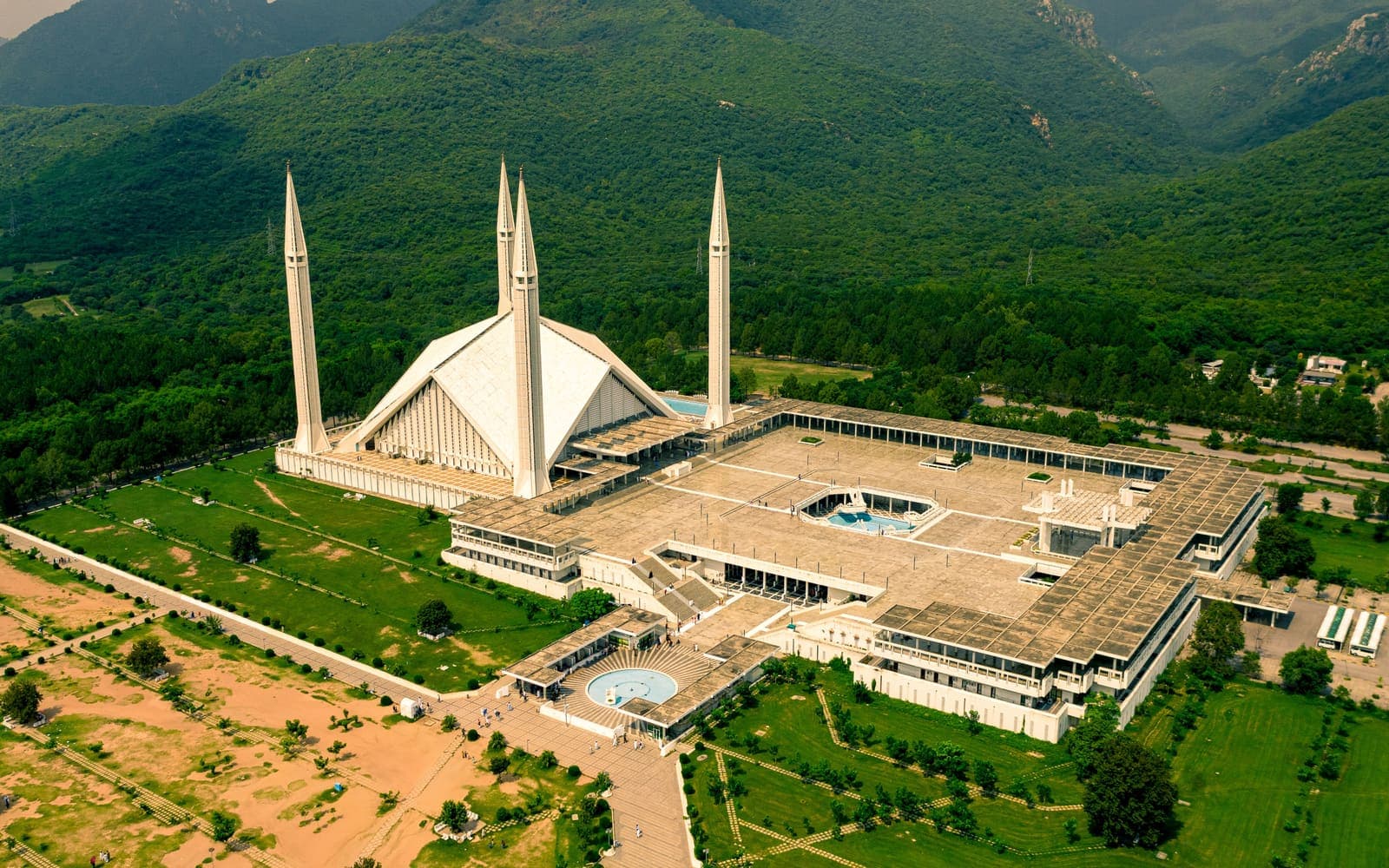 Aerial view of the Faisal Mosque below the green Margalla Hills, Islamabad